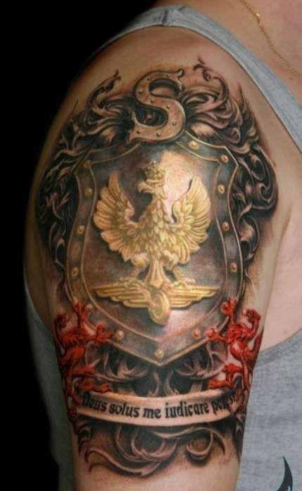 Gorgeous very detailed colorful family crest tattoo on shoulder stylized with lettering