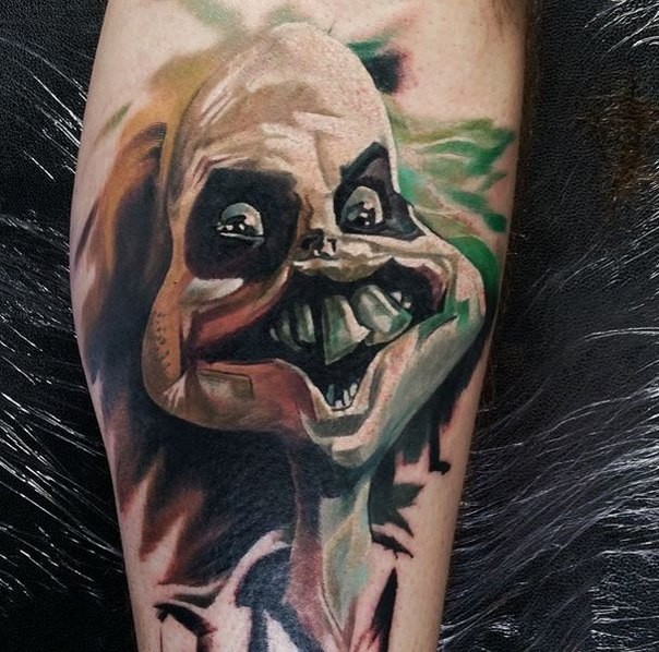 Graffiti style colored leg tattoo of creepy alien face