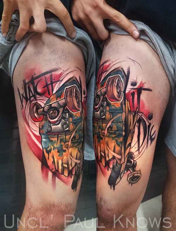 Graffiti style colored thigh tattoo of skateboard with lettering