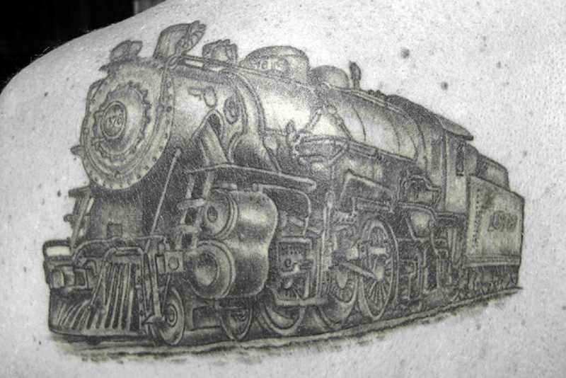 Gray colored scapular tattoo of enormous train