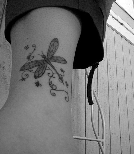 Gray dragonfly ankle tattoo