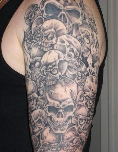 Gray ink a lot of skulls tattoo on half sleeve