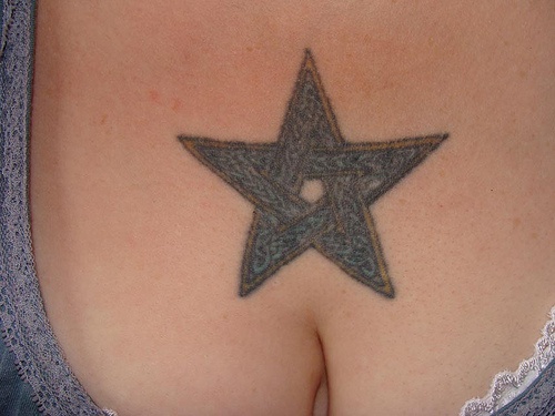 Gray star chest tattoo