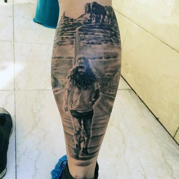 Gray washed detailed leg tattoo of running man in desert