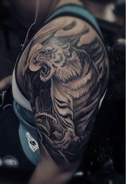 Gray washed shoulder tattoo of tiger with moon
