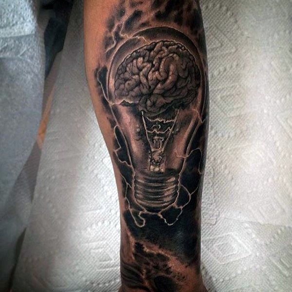 Gray washed style arm tattoo of bulb with brain