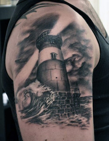 Gray washed style big shoulder tattoo of lighthouse with waves