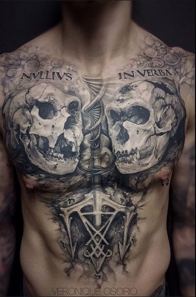 Gray washed style black ink chest tattoo of monkey skulls with lettering and DNA