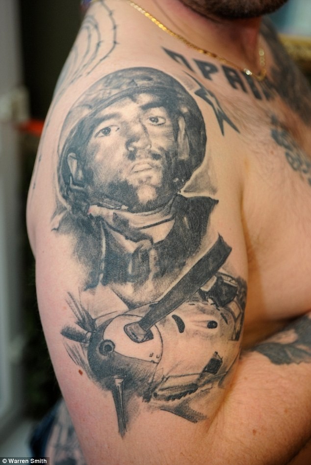 Gray washed style black ink shoulder tattoo of WW2 soldier with plane