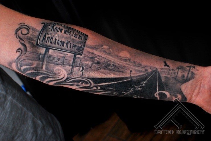Gray washed style colored forearm tattoo of American road with sign