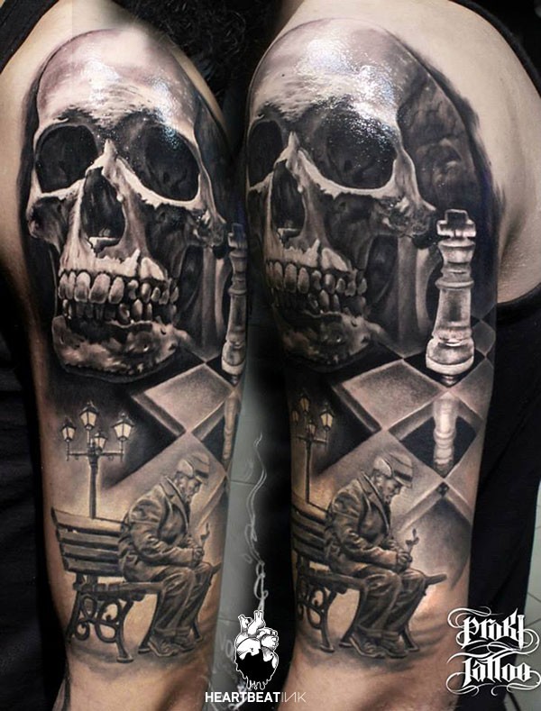 Gray washed style colored shoulder tattoo of human skull with chess player