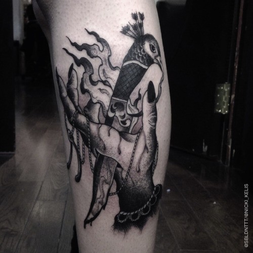 Gray washed style creepy looking leg tattoo of witch hand with dagger