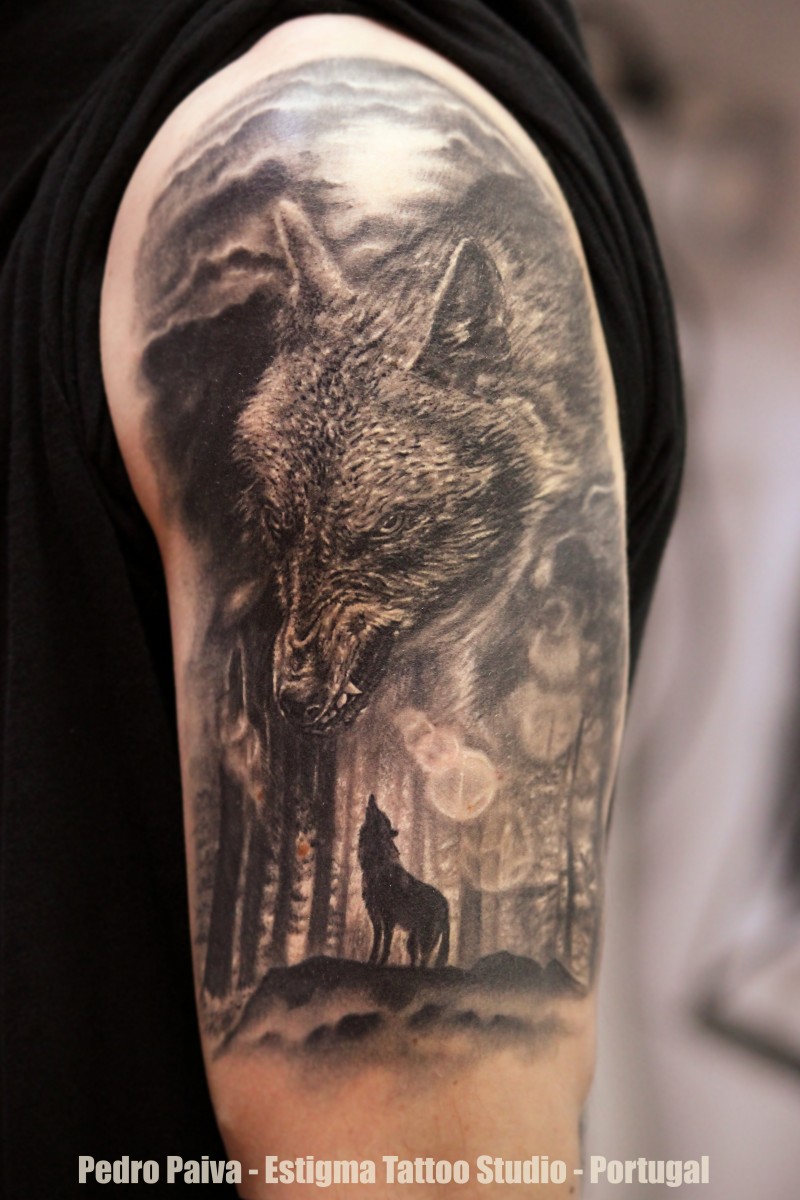 Gray washed style detailed shoulder tattoo of wolf in forest