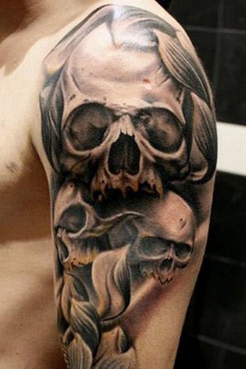 Gray washed style human skulls tattoo on shoulder