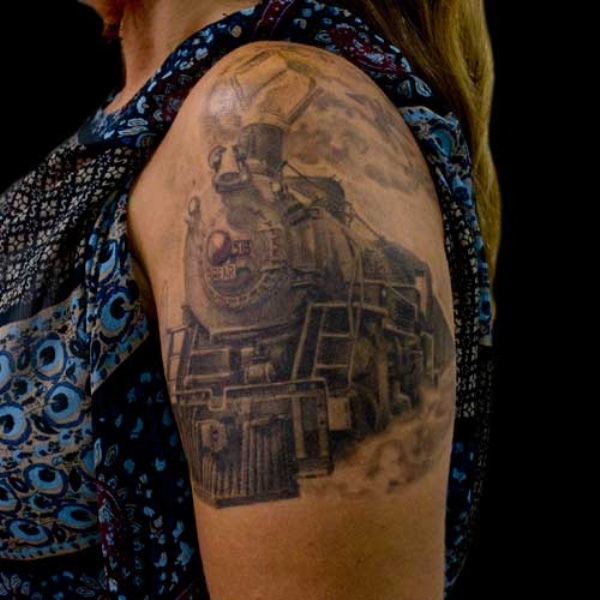 Gray washed style large shoulder tattoo of old train