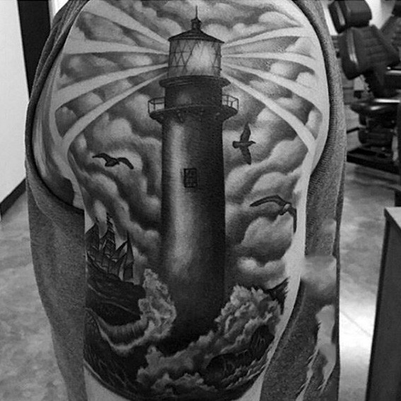 Gray washed style shoulder tattoo of lighthouse with birds