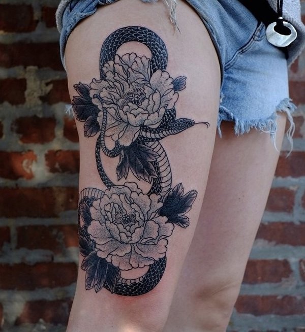 Great black and white detailed snake with flowers tattoo on thigh