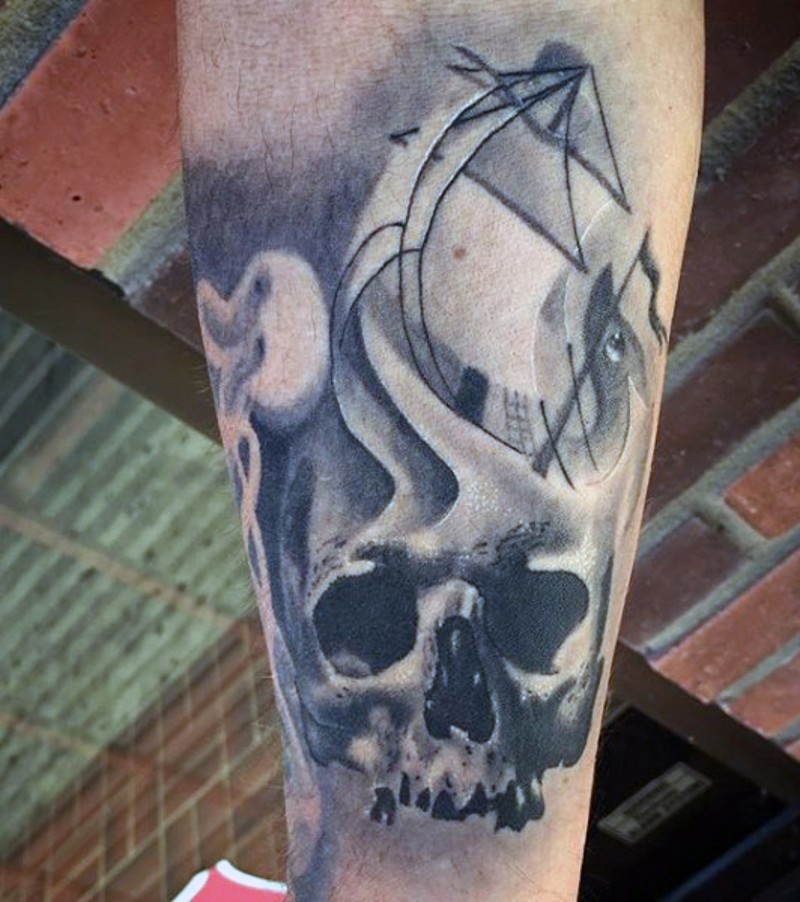 Great painted black and white skull with ship tattoo on leg