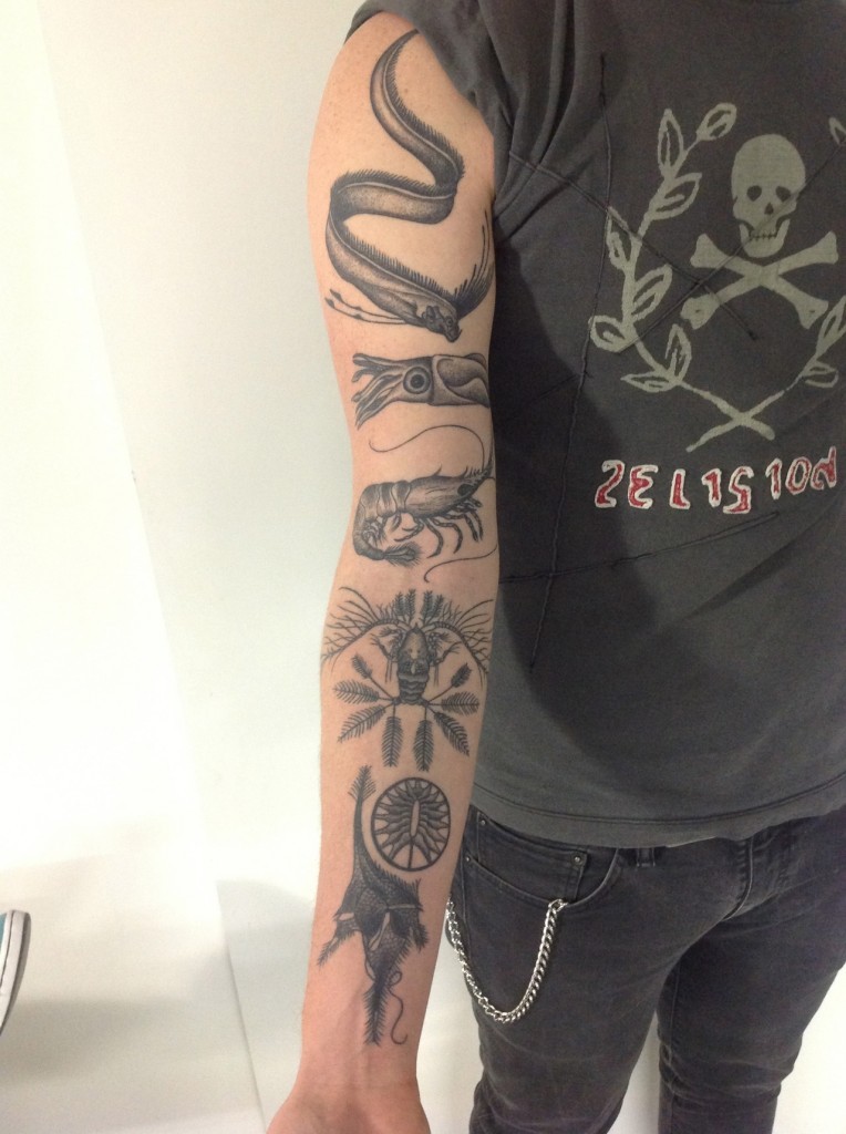Tatuaje en el brazo, varios animales del mar, tinta negra