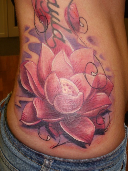 Great pink lotus flower tattoo on ribs