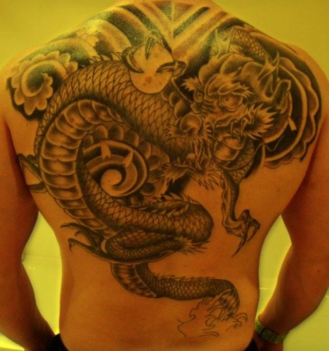 Great wonderful dragon and magic ball tattoo on whole back
