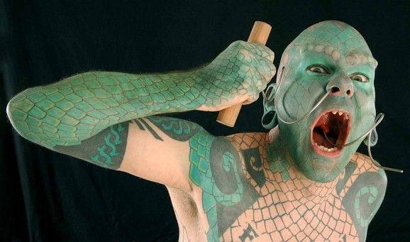 Hombre tatuado como lagarto verde