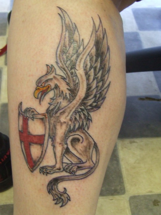 Griffin tattoo on leg for male