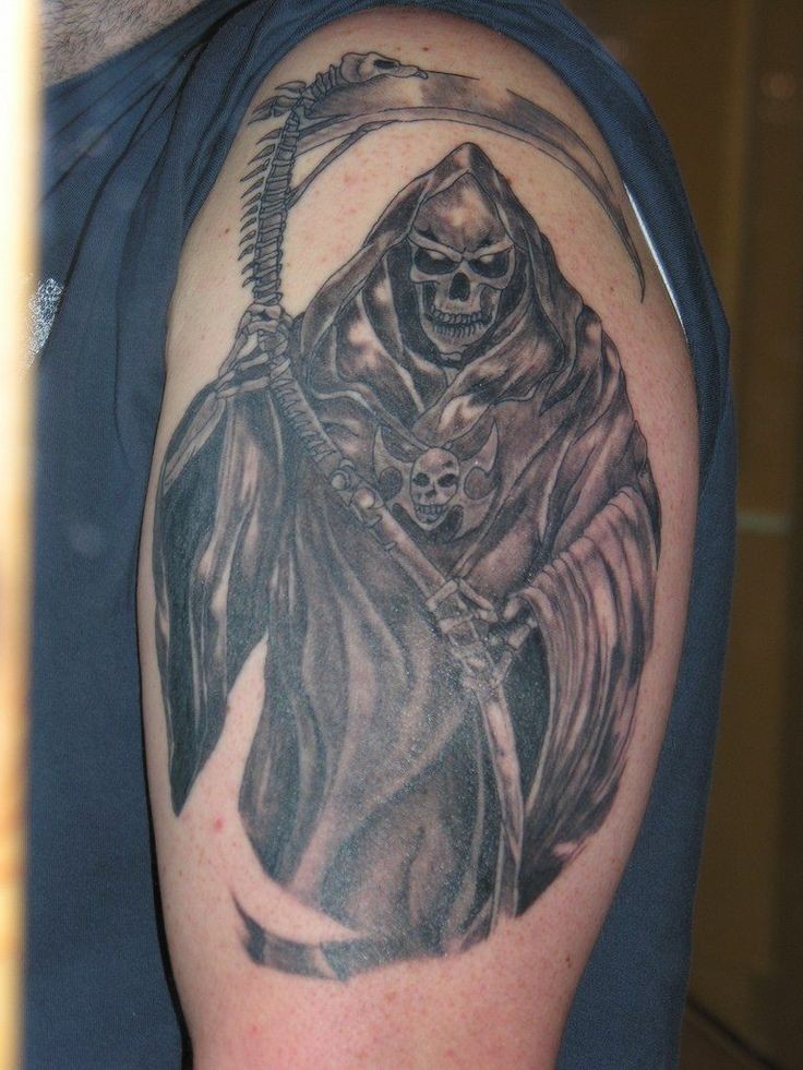 Grim reaper  with amulet tattoo on shoulder