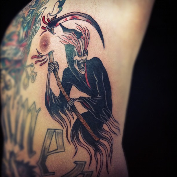 Grim reaper with scythe tattoo on ribs