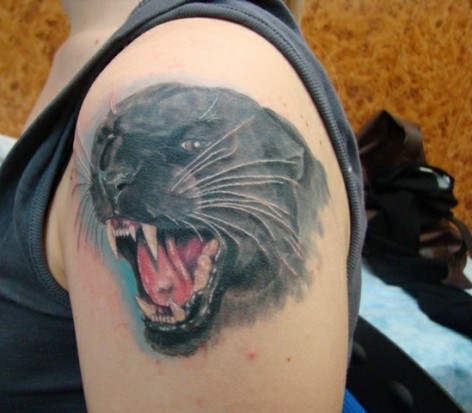 Grin panther tattoo on shoulder