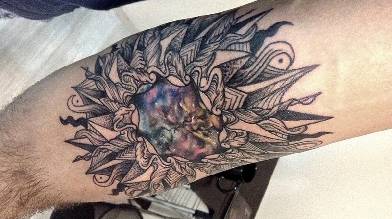 Half colored and detailed tattoo of interesting ornaments and night sky