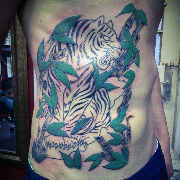 Half colored large side tattoo of tiger in jungle