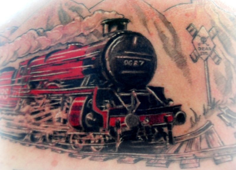 Half colored large tattoo of fast steam train