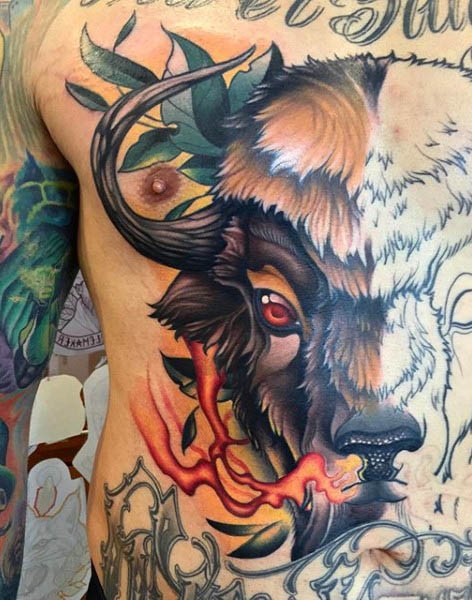 Half colored massive bull tattoo on chest with flames and leaves