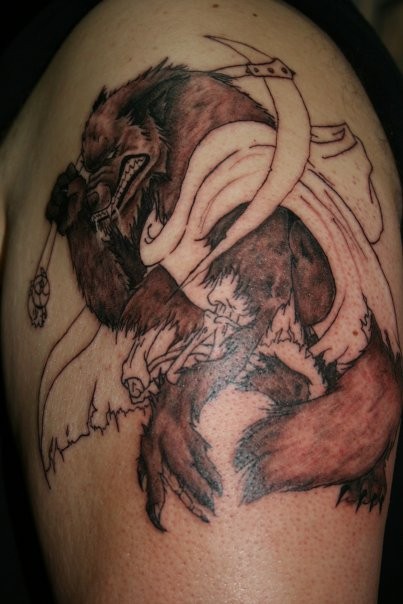 Half colored shoulder tattoo of illustrative werewolf