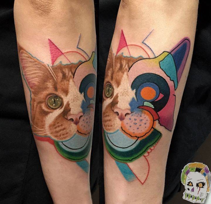 Half realistic half illustrative style colored arm tattoo of cat head