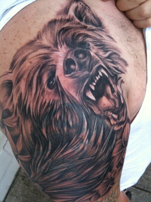 Head snarling bear tattoo on shoulder