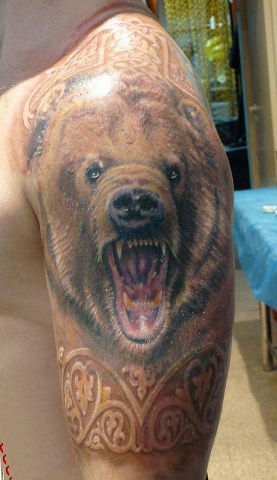 Head snarling bear with patterns tattoo on half sleeve