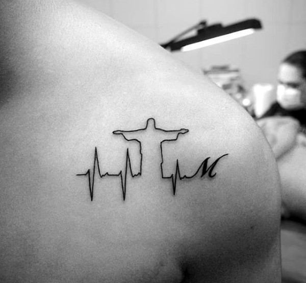 Heart rhythm and Jesus Christ black ink tattoo with letter M on shoulder