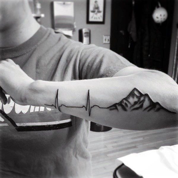 Heart rhythm connected with mountains tattoo on arm