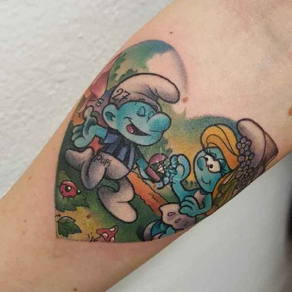 Heart shaped colored The Smurfs proposal romantic cartoon style tattooo on forearm