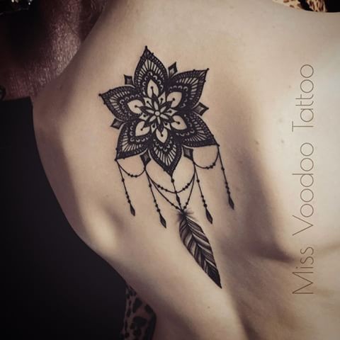 Henna like black ink painted by Caro Voodoo upper back tattoo of big flower with feather