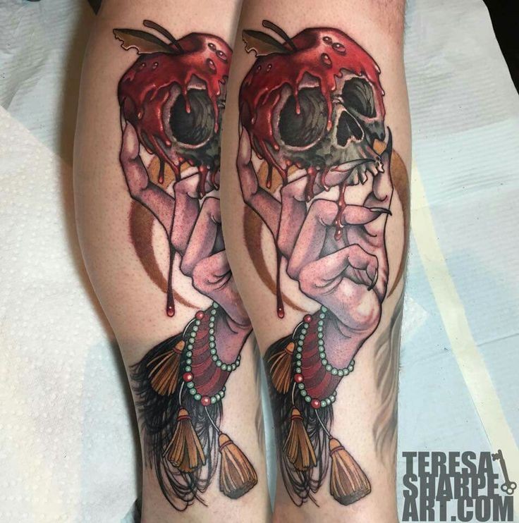 Hilarious colored skull shaped apple tattoo on leg with witch hand