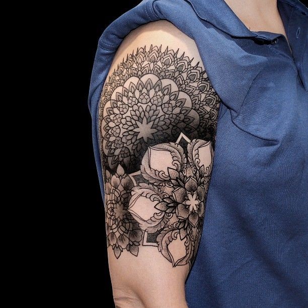 Hinduism style black ink shoulder tattoo of beautiful flowers