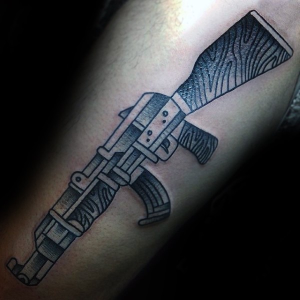 Homemade black ink arm tattoo of AK rifle