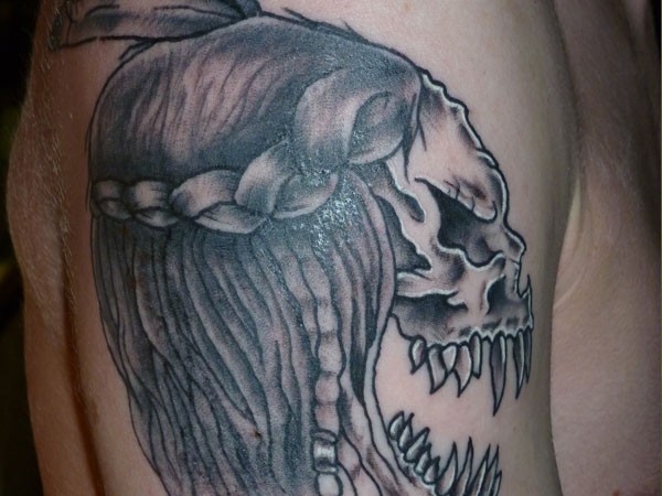 Homemade black ink creepy demonic skull tattoo on shoulder