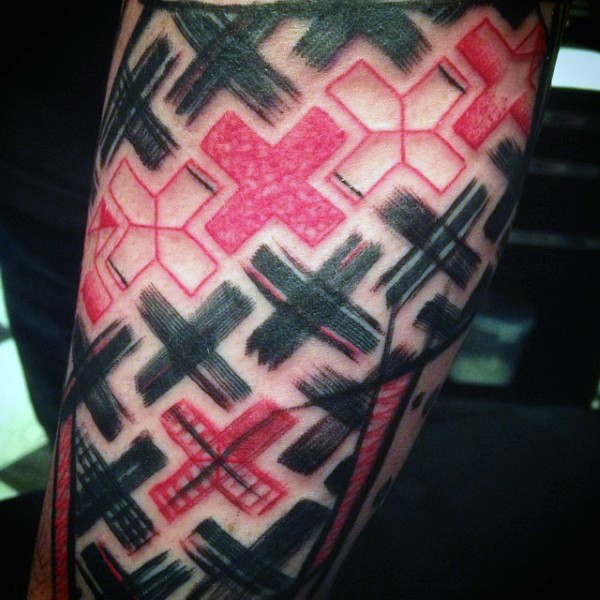 Homemade colored forearm tattoo of colored crosses