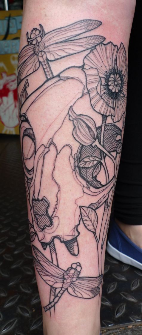 Homemade like black ink animal skull tattoo on leg combined with flowers and dragonfly