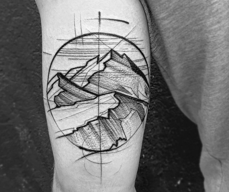 Homemade like black ink circle shaped mountains tattoo on arm