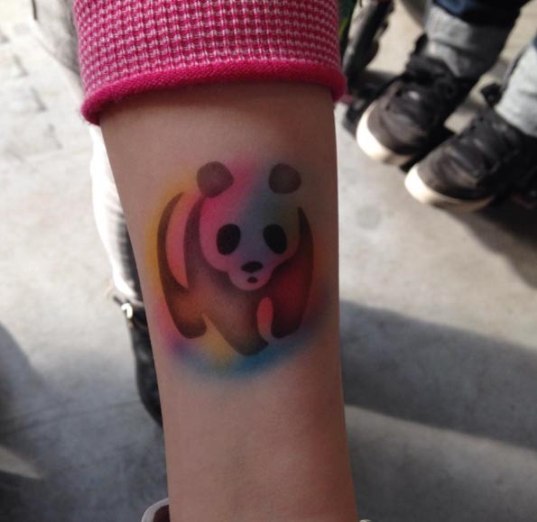 Homemade like colored forearm tattoo of panda silhouette
